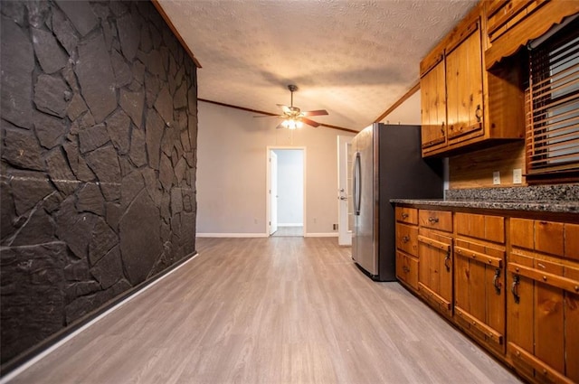 kitchen with light hardwood / wood-style flooring, ceiling fan, ornamental molding, a textured ceiling, and vaulted ceiling