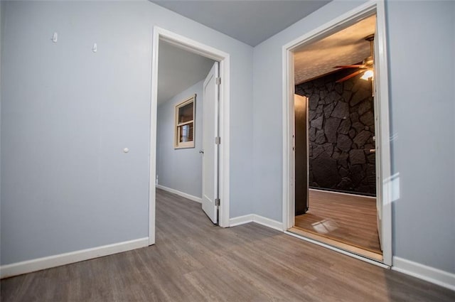 hallway with hardwood / wood-style flooring