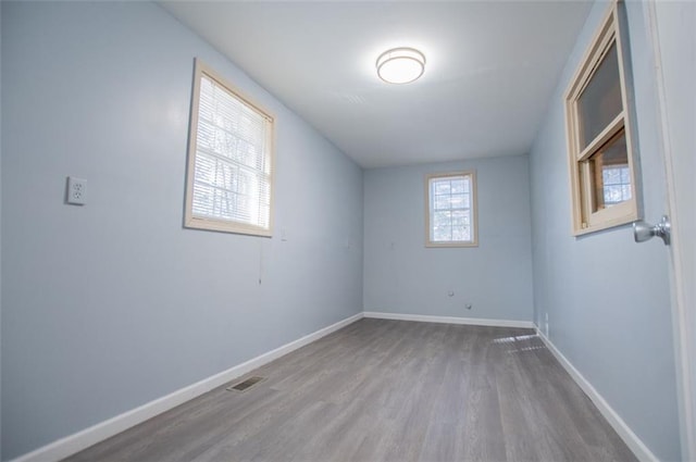 empty room with hardwood / wood-style floors