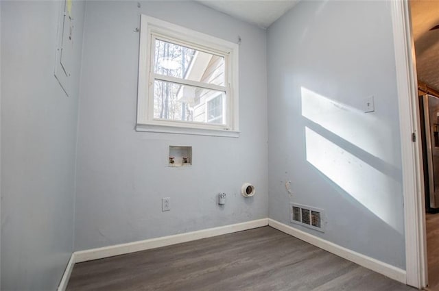 clothes washing area with hardwood / wood-style flooring and washer hookup