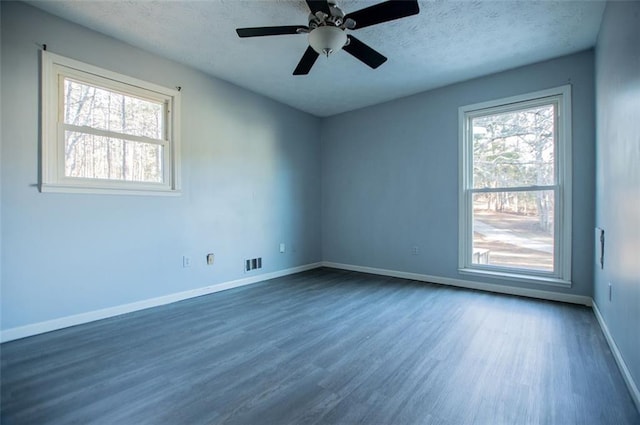 spare room featuring dark hardwood / wood-style floors and ceiling fan