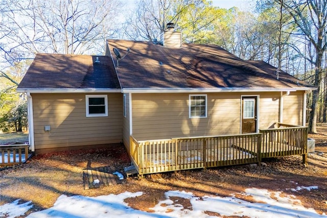 view of snow covered exterior with a wooden deck