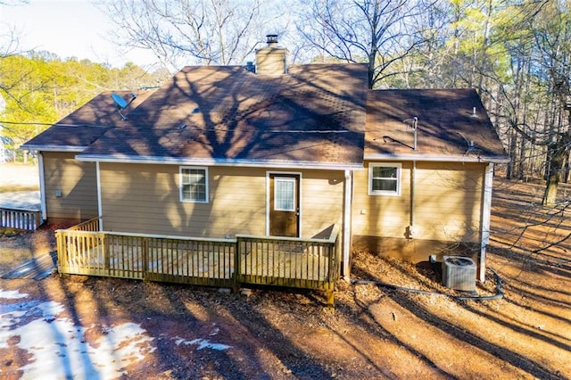 rear view of property with a wooden deck and central AC