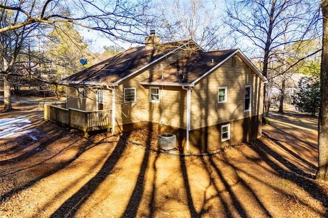 view of property exterior with a wooden deck