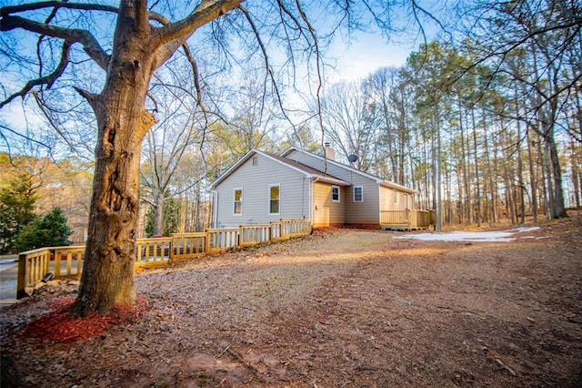 view of side of property with a wooden deck