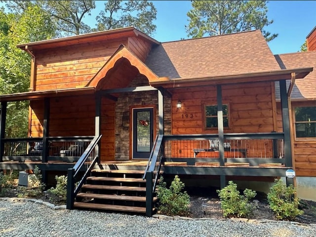 view of front of property with roof with shingles and covered porch