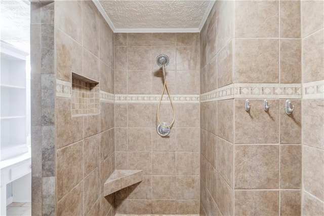 bathroom featuring a textured ceiling and tiled shower