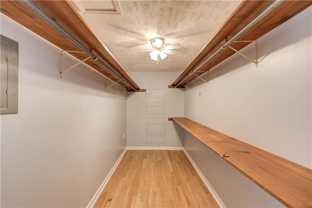 empty room with baseboards, visible vents, ceiling fan, a textured ceiling, and light wood-type flooring