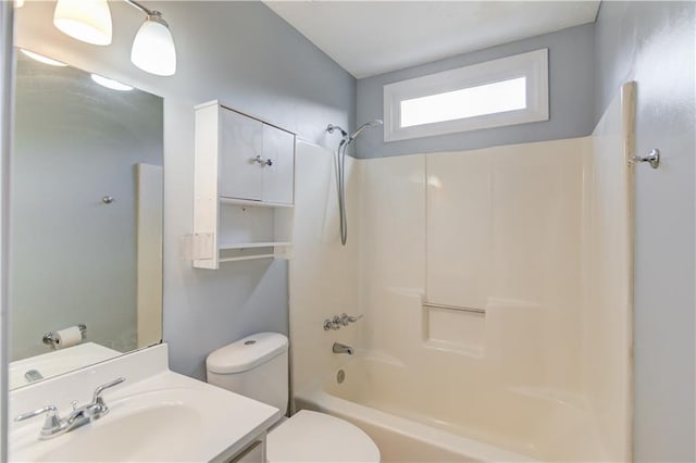 bathroom with vanity, bathtub / shower combination, and toilet