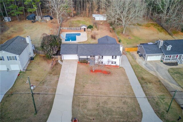 ranch-style home with a garage, a chimney, and fence