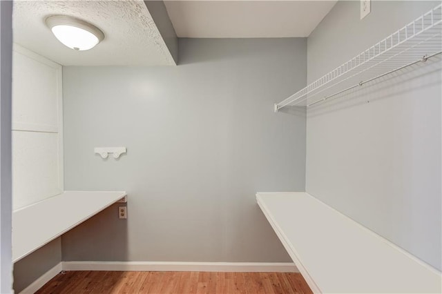 walk in closet featuring wood finished floors