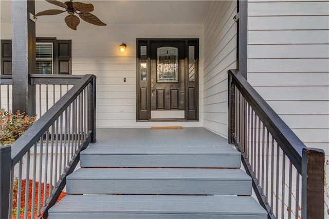 doorway to property featuring ceiling fan and a porch