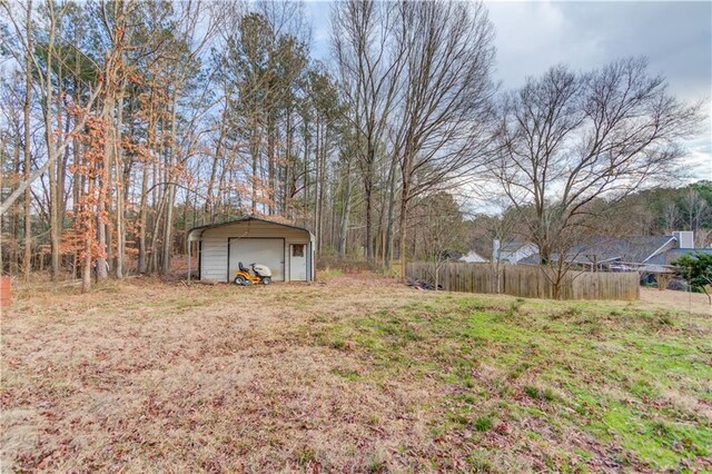 view of outbuilding featuring an outdoor structure and fence