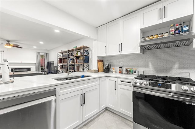 kitchen with white cabinets, sink, ceiling fan, appliances with stainless steel finishes, and tasteful backsplash