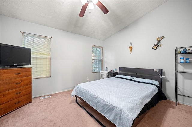 carpeted bedroom featuring a textured ceiling, ceiling fan, and lofted ceiling