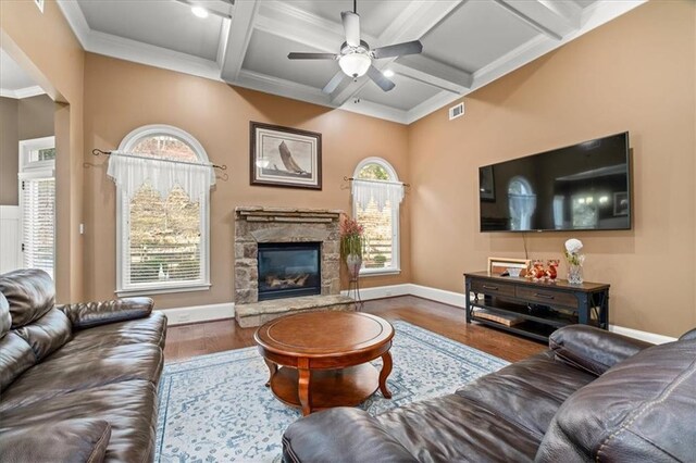 living room with coffered ceiling, hardwood / wood-style flooring, ceiling fan, a fireplace, and beam ceiling