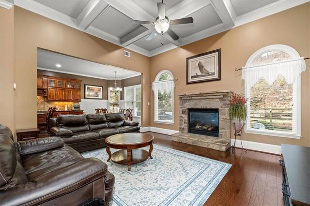 living room with a fireplace, ceiling fan with notable chandelier, dark hardwood / wood-style floors, and coffered ceiling