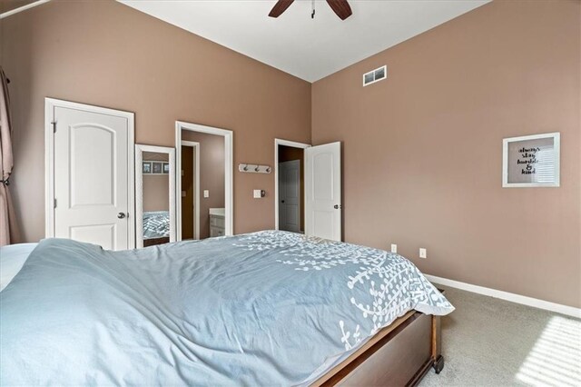 bedroom featuring ensuite bath, ceiling fan, and carpet floors