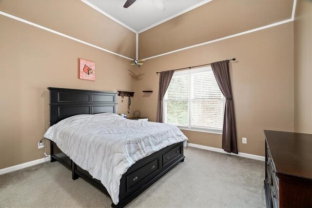 carpeted bedroom with ceiling fan and ornamental molding