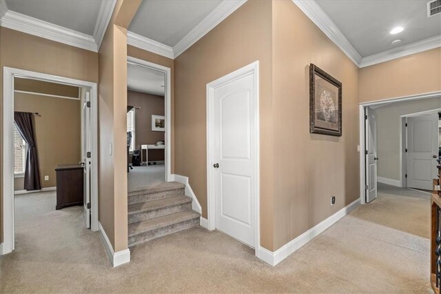 hall featuring crown molding and light carpet