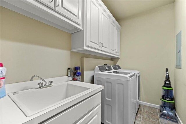 laundry area featuring cabinets, sink, light tile patterned floors, independent washer and dryer, and electric panel