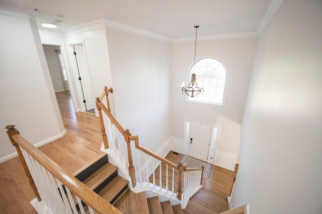 2019 Chelton Way SE, Smyrna, GA 30080 - entryway with baseboards, crown molding, a chandelier, and light wood-type flooring