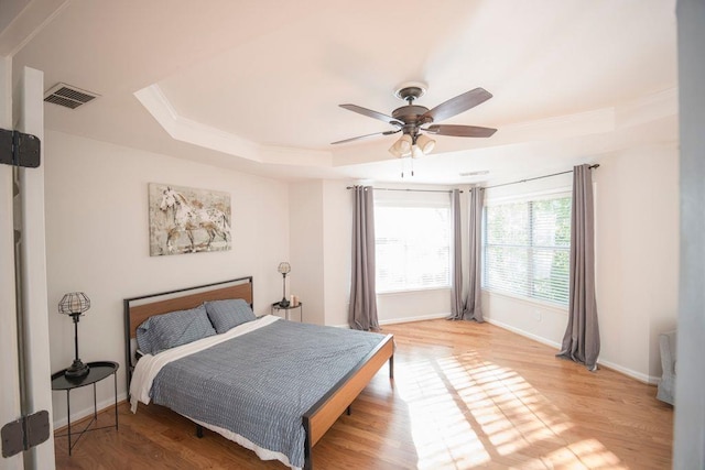 2019 Chelton Way SE, Smyrna, GA 30080 - bedroom with crown molding, light wood-type flooring, a raised ceiling, baseboards, and visible vents