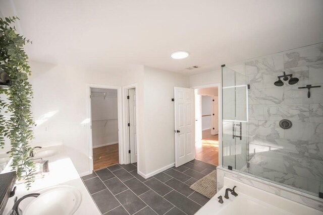 2019 Chelton Way SE, Smyrna, GA 30080 - bathroom featuring baseboards, a sink, a walk in closet, and a stall shower