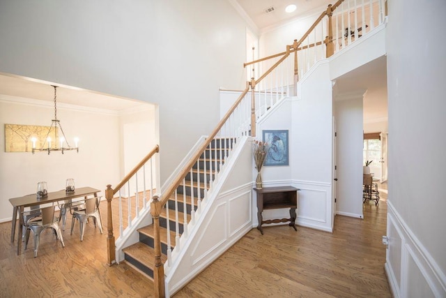 2019 Chelton Way SE, Smyrna, GA 30080 - staircase featuring wood finished floors, a high ceiling, an inviting chandelier, and ornamental molding
