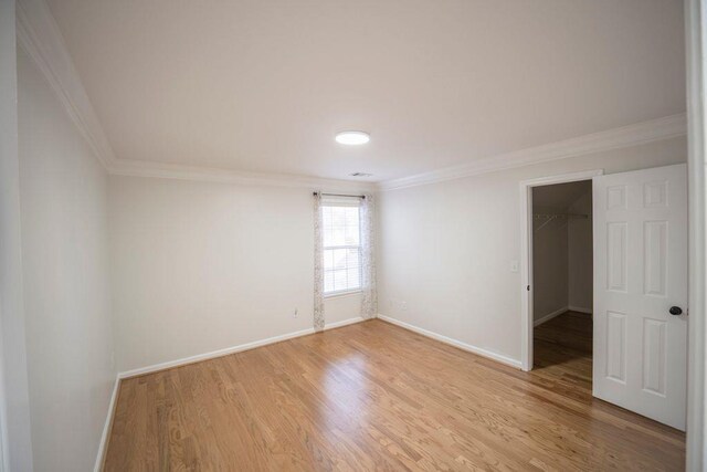 2019 Chelton Way SE, Smyrna, GA 30080 - empty room featuring baseboards, ornamental molding, and light wood finished floors