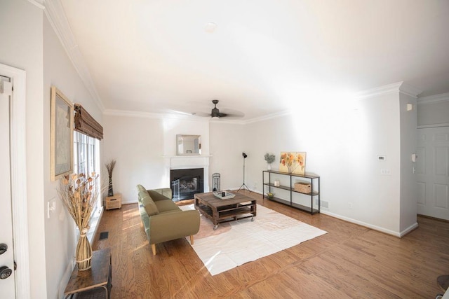 2019 Chelton Way SE, Smyrna, GA 30080 - living area with wood finished floors, a ceiling fan, crown molding, baseboards, and a glass covered fireplace