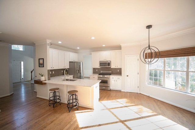 2019 Chelton Way SE, Smyrna, GA 30080 - kitchen featuring tasteful backsplash, a sink, a breakfast bar, stainless steel appliances, and a peninsula