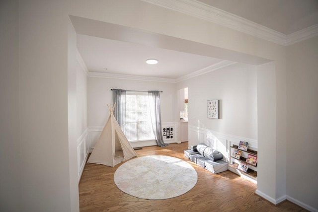 2019 Chelton Way SE, Smyrna, GA 30080 - recreation room featuring a decorative wall, ornamental molding, a wainscoted wall, and wood finished floors