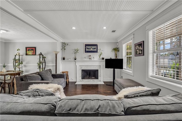 living room with ornamental molding, a premium fireplace, and dark hardwood / wood-style flooring