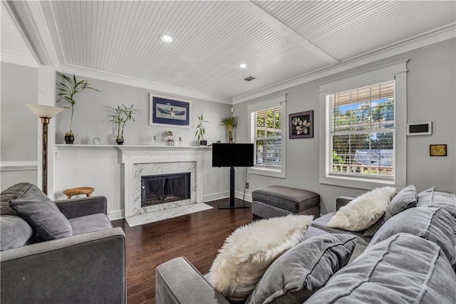 living room featuring a premium fireplace, ornamental molding, and dark hardwood / wood-style flooring