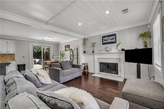 living room featuring ornamental molding, a premium fireplace, and dark hardwood / wood-style flooring