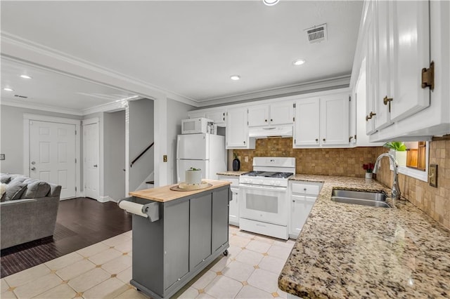 kitchen with a kitchen island, ornamental molding, sink, white cabinets, and white appliances