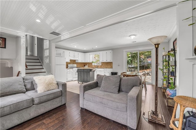 living room featuring dark wood-type flooring and crown molding