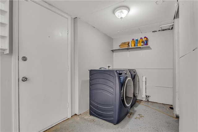 clothes washing area featuring washer and dryer