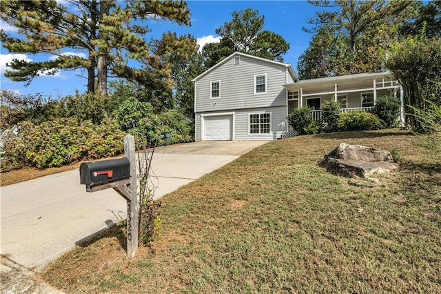 tri-level home with a front yard and a garage