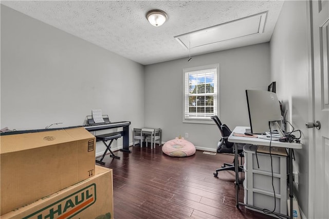 office space with a textured ceiling and dark wood-type flooring