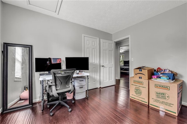 office featuring a textured ceiling and dark wood-type flooring