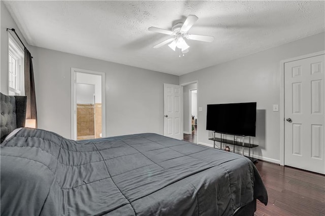 bedroom with dark hardwood / wood-style flooring, a textured ceiling, ensuite bath, and ceiling fan