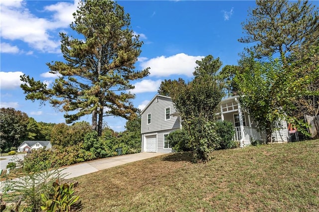 view of side of property with a yard and a garage