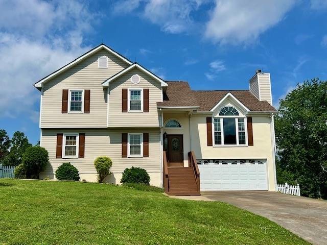 19 Magnolia Ct NE, Rydal, GA 30171 - tri-level home with concrete driveway, a garage, and a chimney