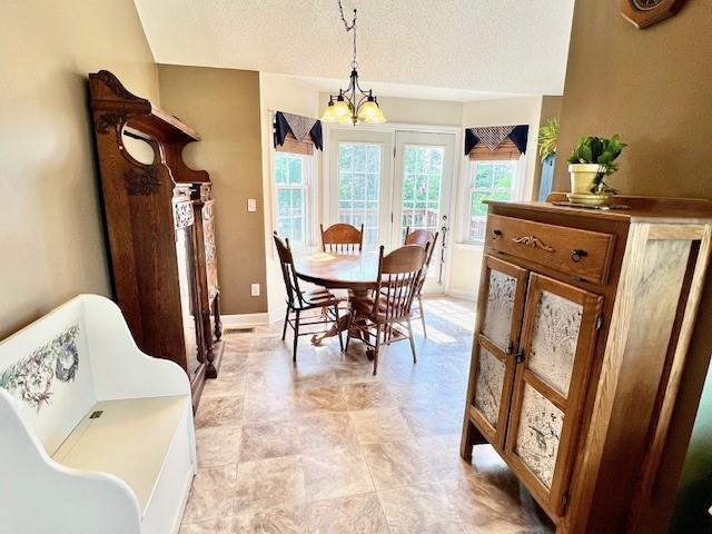 19 Magnolia Ct NE, Rydal, GA 30171 - dining space with a chandelier and a textured ceiling