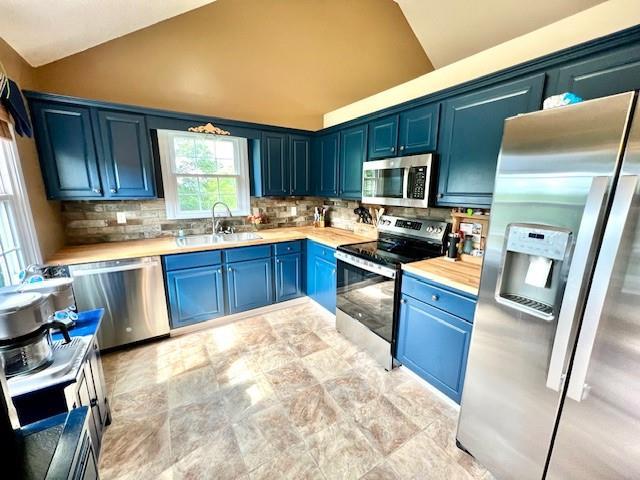 19 Magnolia Ct NE, Rydal, GA 30171 - kitchen featuring stainless steel appliances, a sink, blue cabinetry, light countertops, and backsplash