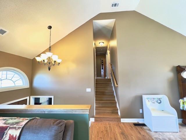 19 Magnolia Ct NE, Rydal, GA 30171 - stairway with a chandelier, lofted ceiling, wood finished floors, and baseboards