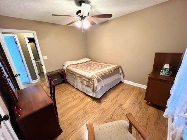 19 Magnolia Ct NE, Rydal, GA 30171 - bedroom with light wood-type flooring, baseboards, and ceiling fan