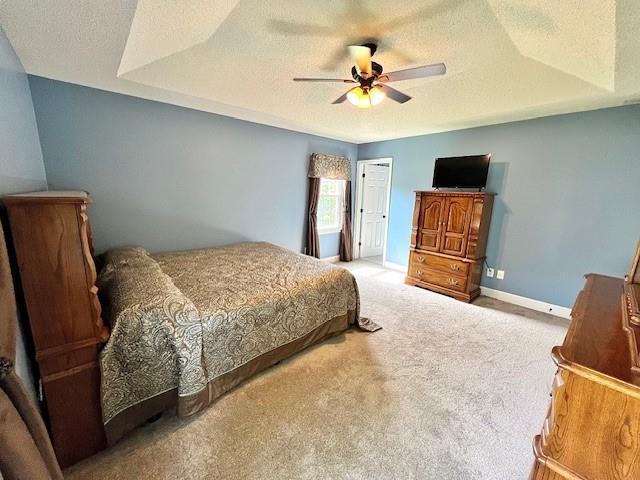 19 Magnolia Ct NE, Rydal, GA 30171 - bedroom featuring carpet floors, a textured ceiling, baseboards, and a ceiling fan